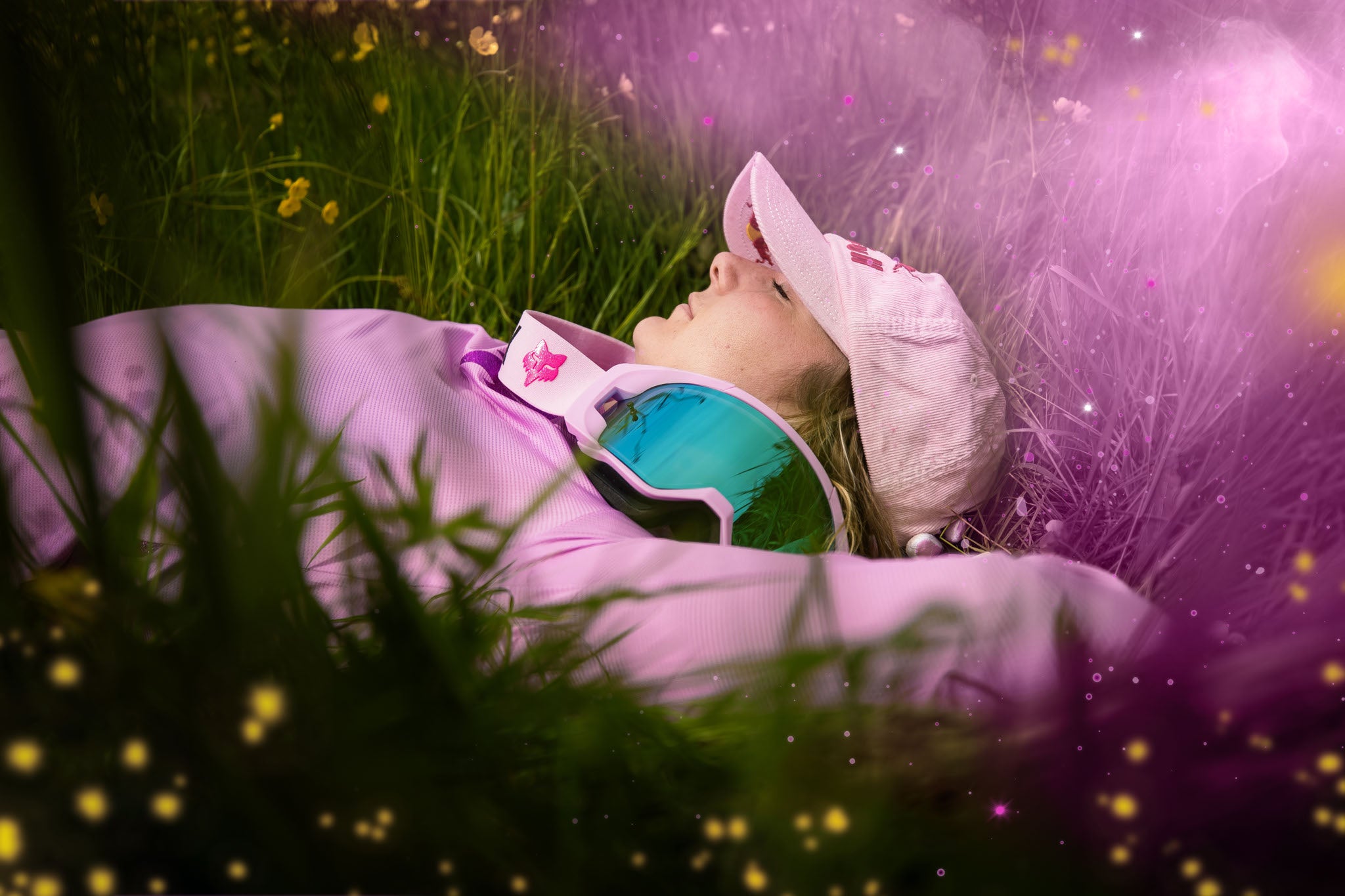 Person in pinker Kleidung mit Fox-Maske, liegt in einer Wiese; Fox-Tahnee-Seagrave Collection erkennbar.