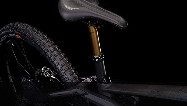 Mountainbike-Sattel und Hinterrad mit grobem Profil, geeignet für Offroad-Trails. Fox-Federung sichtbar.