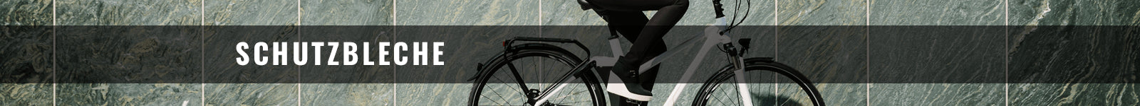 Fahrrad mit Schutzblechen auf grauem Steinboden, ideal für Allwetterfahrer. Markenname und Modell nicht erkennbar.