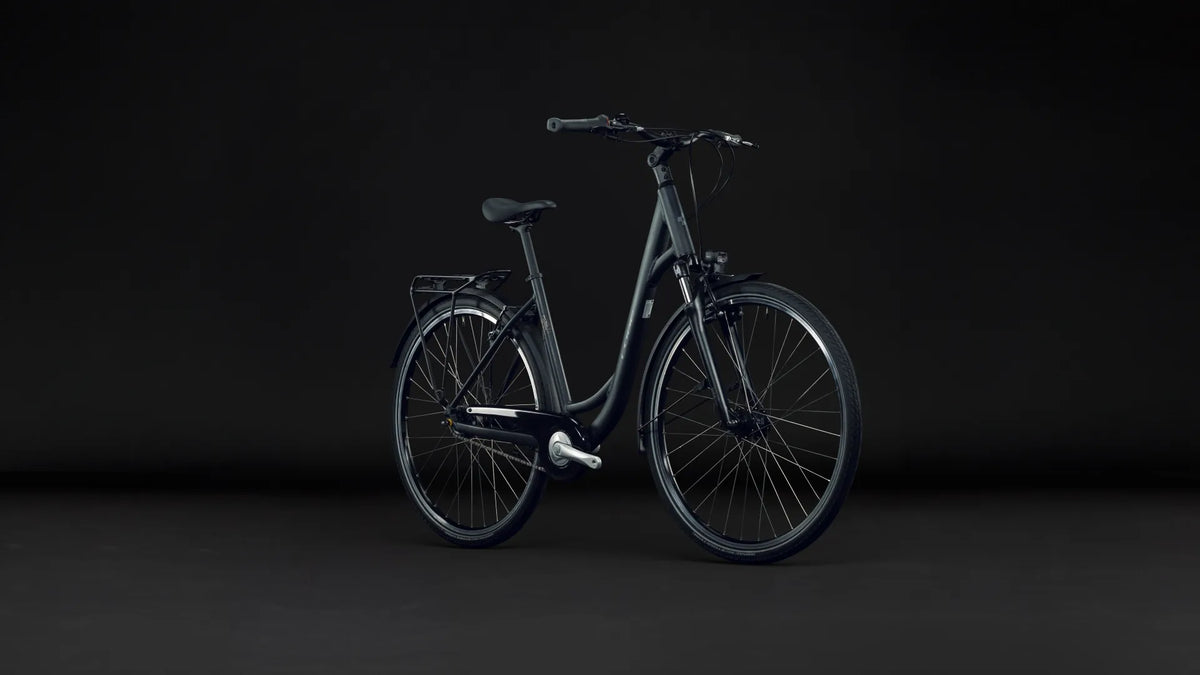 Dunkelblaues Cube TOWN ONE
2027 mit tiefem Einstieg, Gepäckträger, schwarzem Sattel und Schutzblechen, Beleuchtung - geeignet für den Stadtverkehr.